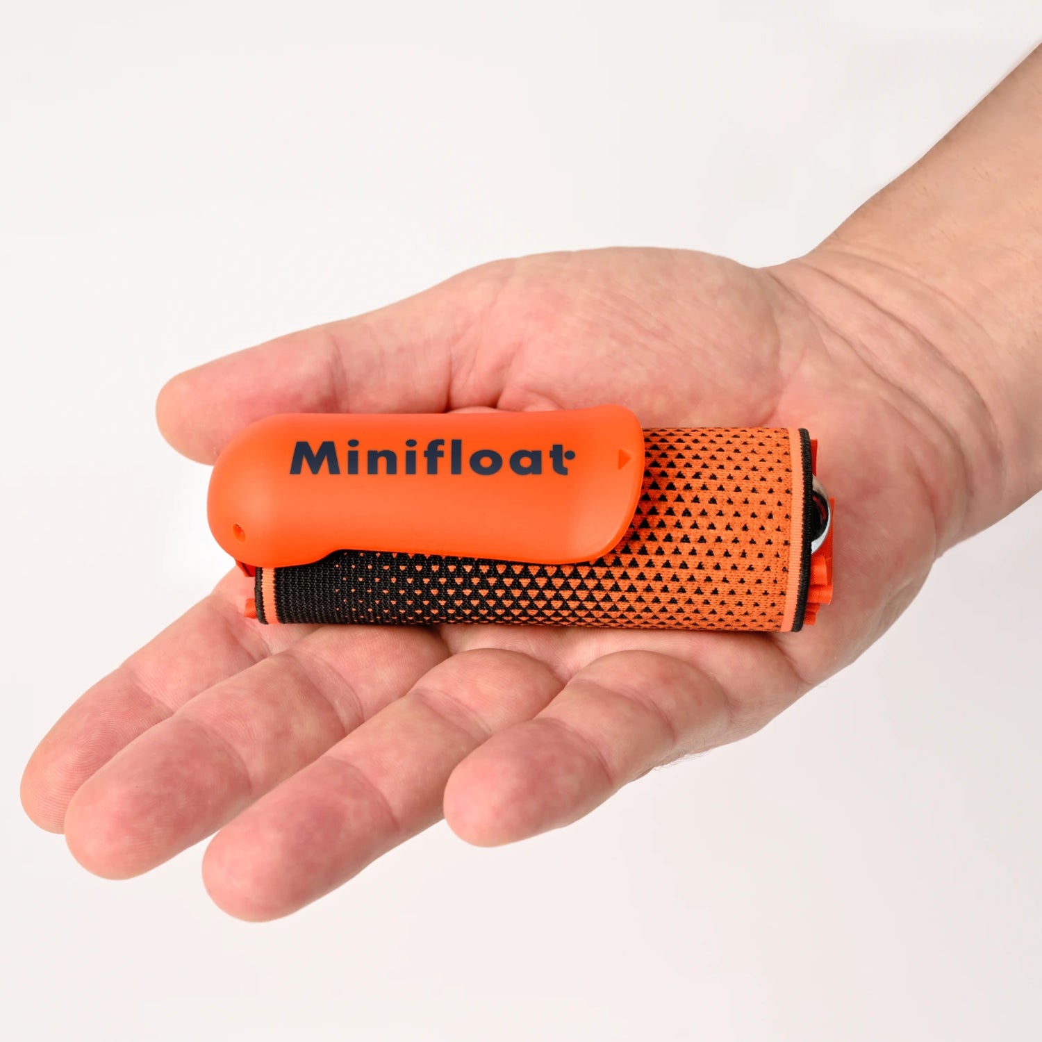 Orange 'Minifloat' device held in a hand against a white background